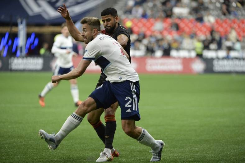 May 11, 2022; Vancouver, British Columbia, Canada;  Vancouver Whitecaps defender Erik Godoy (22) battles for the ball against Valour FC midfielder Moses Dyer (7) during the second half at BC Place. Mandatory Credit: Anne-Marie Sorvin-USA TODAY Sports