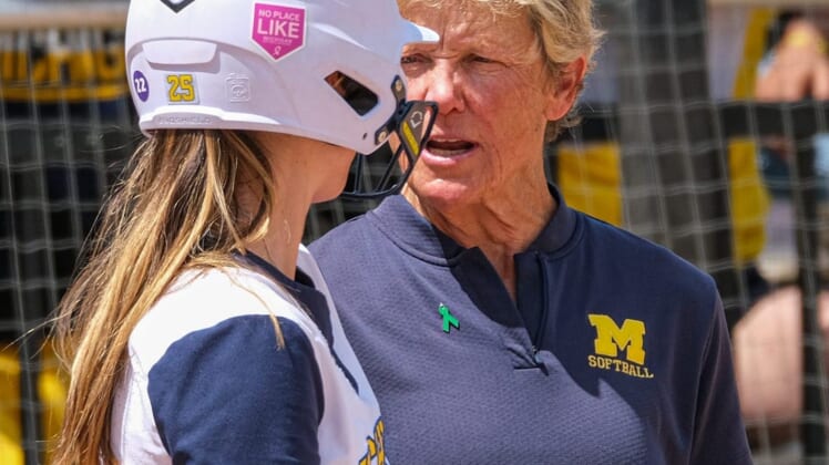 With players in scoring position, Michigan Head Softball Coach Carol Hutchins talks with Audrey LeClair (25) before she bats in the Big Ten Softball Championship Game at Secchia Stadium Saturday, May 14, 2022.Nebraska Uofm Softball 11