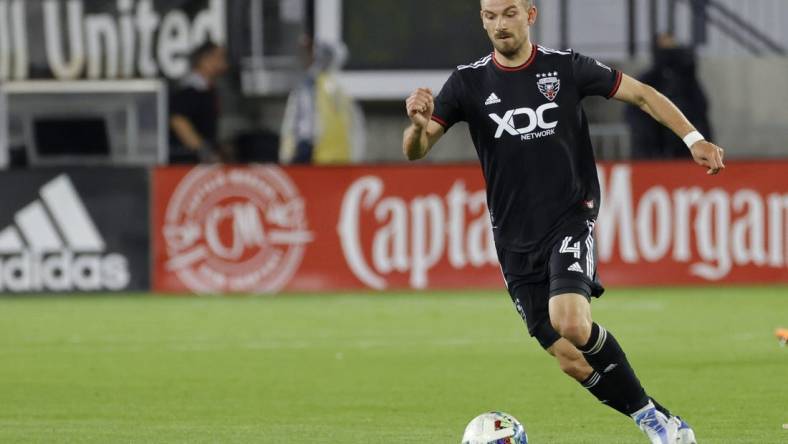 May 18, 2022; Washington, District of Columbia, USA; D.C. United defender Brendan Hines-Ike (4) dribbles the ball against New York City FC at Audi Field. Mandatory Credit: Geoff Burke-USA TODAY Sports