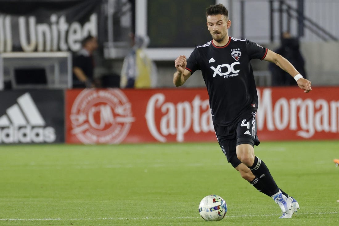 May 18, 2022; Washington, District of Columbia, USA; D.C. United defender Brendan Hines-Ike (4) dribbles the ball against New York City FC at Audi Field. Mandatory Credit: Geoff Burke-USA TODAY Sports