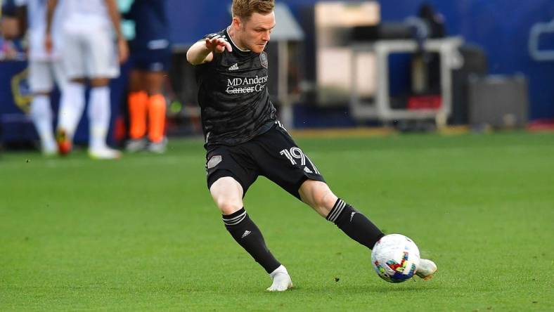 May 22, 2022; Carson, California, USA; Houston Dynamo forward Tyler Pasher (19) scores a goal against the Los Angeles Galaxy during the second half at Dignity Health Sports Park. Mandatory Credit: Gary A. Vasquez-USA TODAY Sports