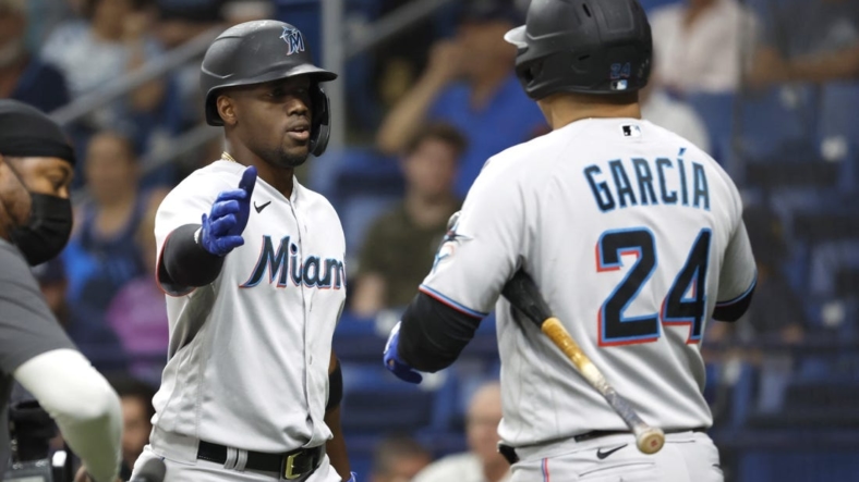May 25, 2022; St. Petersburg, Florida, USA; Miami Marlins right fielder Jorge Soler (12) is congratulated by right fielder Avisail Garcia (24) as he hits a home run during the fourth inning against the Tampa Bay Rays  at Tropicana Field. Mandatory Credit: Kim Klement-USA TODAY Sports