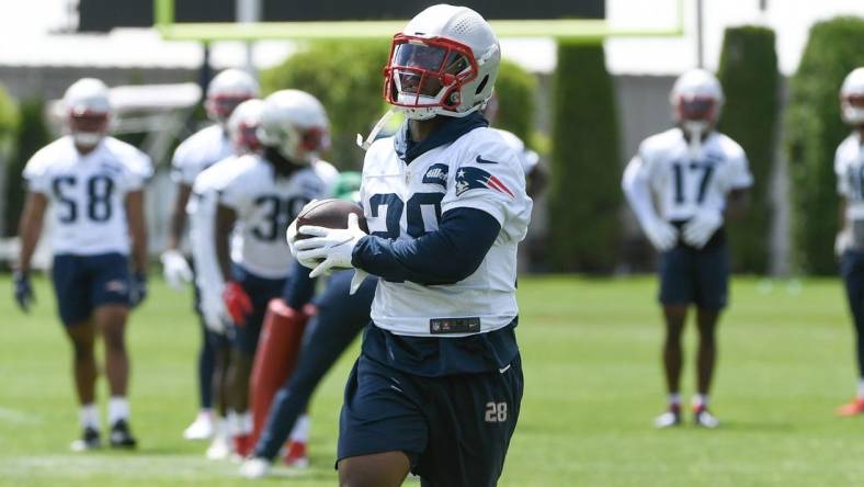 May 23, 2022; Foxborough, MA, USA; New England Patriots running back James White (28) catches the ball at the team's OTA at Gillette Stadium. Mandatory Credit: Eric Canha-USA TODAY Sports