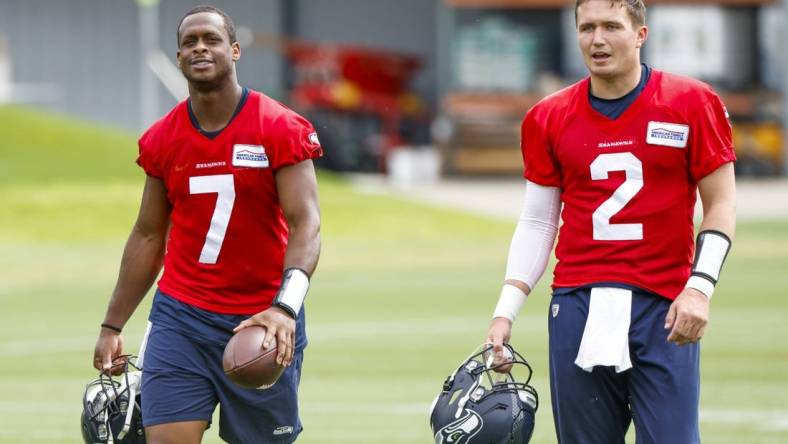 Jun 7, 2022; Renton, Washington, USA; Seattle Seahawks quarterback Geno Smith (7) and quarterback Drew Lock (2) return to the locker room following  minicamp practice at the Virginia Mason Athletic Center Field. Mandatory Credit: Joe Nicholson-USA TODAY Sports