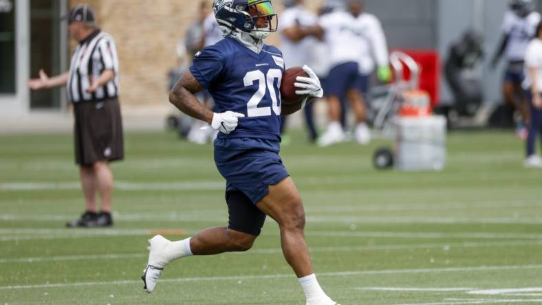 Jun 7, 2022; Renton, Washington, USA; Seattle Seahawks running back Rashaad Penny (20) rushes a drill during minicamp practice at the Virginia Mason Athletic Center Field. Mandatory Credit: Joe Nicholson-USA TODAY Sports