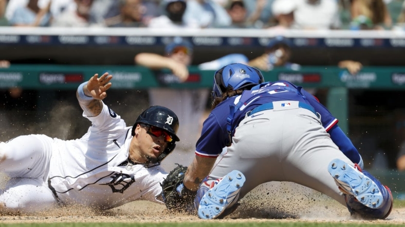 Jun 19, 2022; Detroit, Michigan, USA;  Detroit Tigers shortstop Javier Baez (28) slides in safe at home ahead of the tag by Texas Rangers catcher Jonah Heim (28) in the fifth inning at Comerica Park. Mandatory Credit: Rick Osentoski-USA TODAY Sports