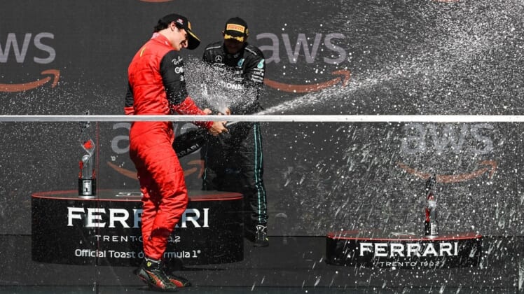 Jun 19, 2022; Montreal, Quebec, CAN; Mercedes driver Lewis Hamilton of United Kingdom showers Ferrari driver Carlos Sainz of Spain with champagne after the Montreal Grand Prix at Circuit Gilles Villeneuve. Mandatory Credit: David Kirouac-USA TODAY Sports
