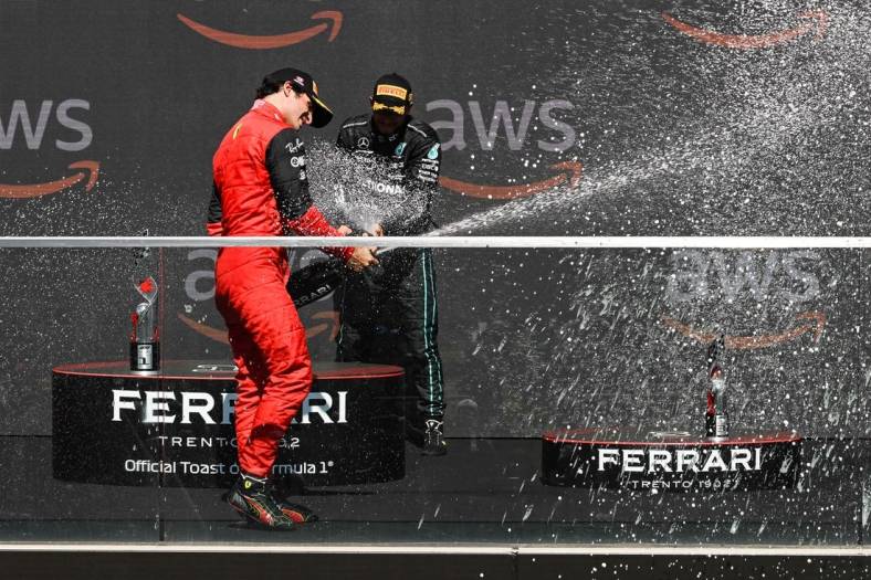 Jun 19, 2022; Montreal, Quebec, CAN; Mercedes driver Lewis Hamilton of United Kingdom showers Ferrari driver Carlos Sainz of Spain with champagne after the Montreal Grand Prix at Circuit Gilles Villeneuve. Mandatory Credit: David Kirouac-USA TODAY Sports