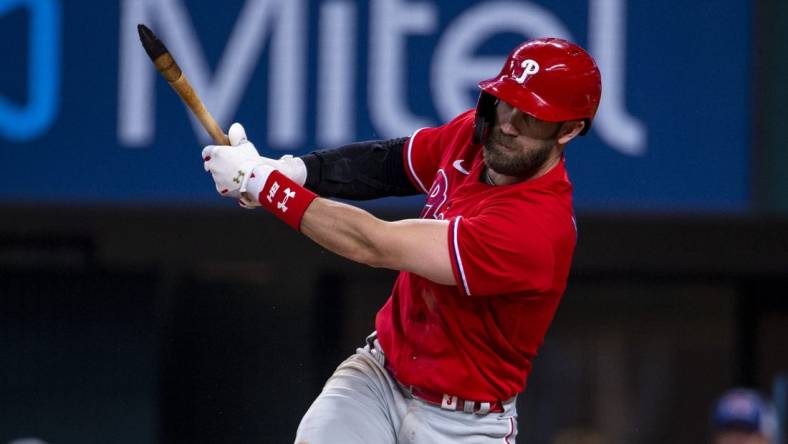 Jun 22, 2022; Arlington, Texas, USA; Philadelphia Phillies designated hitter Bryce Harper (3) breaks his bat while batting against the Texas Rangers during the eighth inning at Globe Life Field. Mandatory Credit: Jerome Miron-USA TODAY Sports