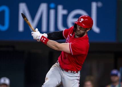 Jun 22, 2022; Arlington, Texas, USA; Philadelphia Phillies designated hitter Bryce Harper (3) breaks his bat while batting against the Texas Rangers during the eighth inning at Globe Life Field. Mandatory Credit: Jerome Miron-USA TODAY Sports
