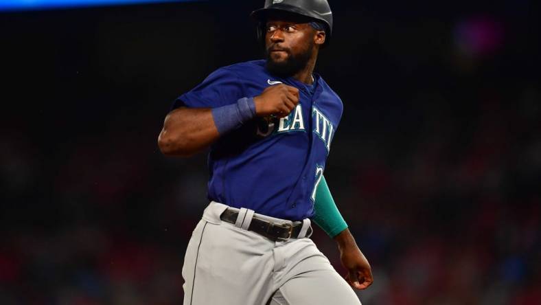 June 25, 2022; Anaheim, California, USA; Seattle Mariners pinch runner Taylor Trammell (20) reaches third against the Los Angeles Angels during the seventh inning at Angel Stadium. Mandatory Credit: Gary A. Vasquez-USA TODAY Sports