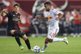 Jun 30, 2022; Harrison, New Jersey, USA; New York Red Bulls midfielder Cristian Casseres Jr (23) plays the ball against Atlanta United defender Caleb Wiley (26) during the second half at Red Bull Arena. Mandatory Credit: Vincent Carchietta-USA TODAY Sports