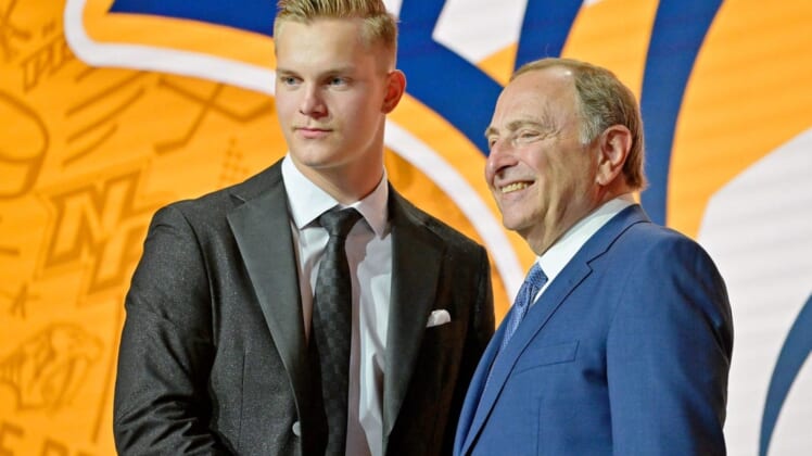 Jul 7, 2022; Montreal, Quebec, CANADA; Joakim Kemell shakes hands with NHL commissioner Gary Bettman after being selected as the No. 17 overall pick to the Nashville Predators in the first round of the 2022 NHL Draft at Bell Centre. Mandatory Credit: Eric Bolte-USA TODAY Sports