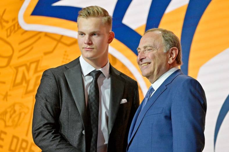 Jul 7, 2022; Montreal, Quebec, CANADA; Joakim Kemell shakes hands with NHL commissioner Gary Bettman after being selected as the No. 17 overall pick to the Nashville Predators in the first round of the 2022 NHL Draft at Bell Centre. Mandatory Credit: Eric Bolte-USA TODAY Sports