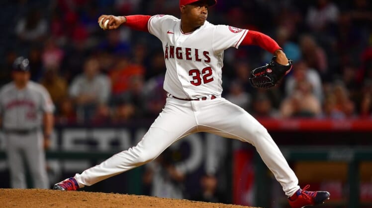 Jul 12, 2022; Anaheim, California, USA; Los Angeles Angels relief pitcher Raisel Iglesias (32) throws against the Houston Astros during the ninth inning at Angel Stadium. Mandatory Credit: Gary A. Vasquez-USA TODAY Sports