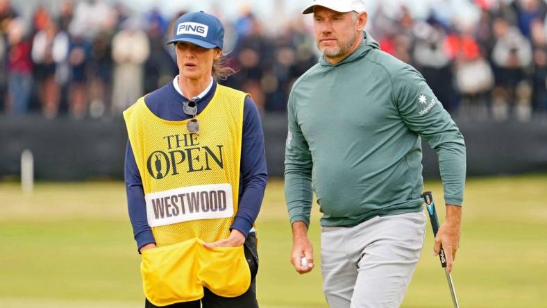 Jul 14, 2022; St. Andrews, SCT; Lee Westwood stands on the 17th green with his wife and caddie Helen Storey during the first round of the 150th Open Championship golf tournament at St. Andrews Old Course. Mandatory Credit: Rob Schumacher-USA TODAY Sports