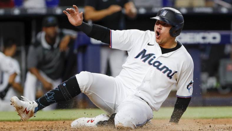 Jul 14, 2022; Miami, Florida, USA; Miami Marlins designated hitter Avisail Garcia (24) scores the winning run after a triple by third baseman Brian Anderson (not pictured) during the eleventh inning against the Pittsburgh Pirates at loanDepot Park. Mandatory Credit: Sam Navarro-USA TODAY Sports