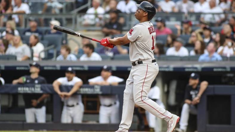 Jul 16, 2022; Bronx, New York, USA; Boston Red Sox third baseman Rafael Devers (11) hits a solo home run in the first inning against the New York Yankees at Yankee Stadium. Mandatory Credit: Wendell Cruz-USA TODAY Sports