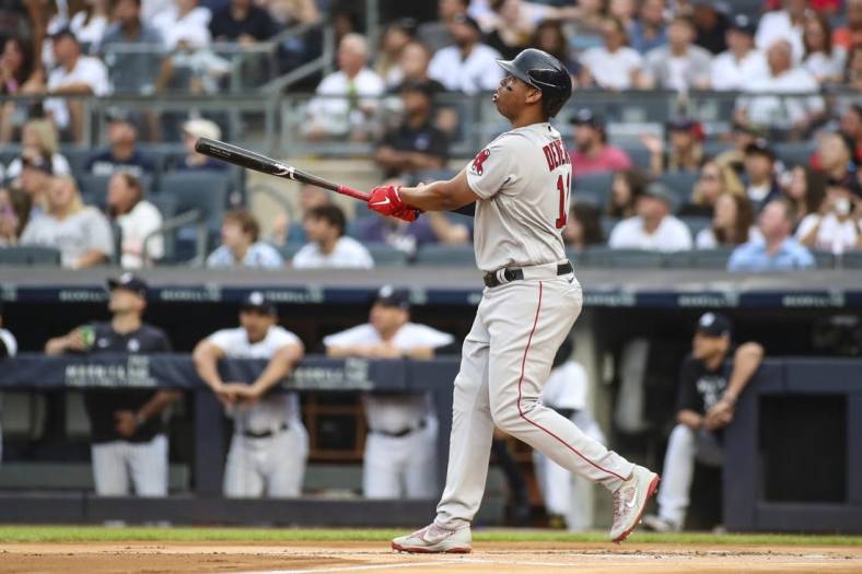 Jul 16, 2022; Bronx, New York, USA; Boston Red Sox third baseman Rafael Devers (11) hits a solo home run in the first inning against the New York Yankees at Yankee Stadium. Mandatory Credit: Wendell Cruz-USA TODAY Sports
