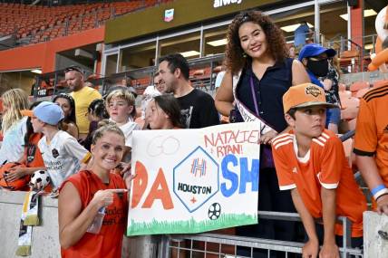 Jul 16, 2022; Houston, Texas, USA; Houston Dash forward Natalie Jacobs (30) poses by a sign with fans after the match against the Chicago Red Stars in a NWSL match at PNC Stadium. Mandatory Credit: Maria Lysaker-USA TODAY Sports