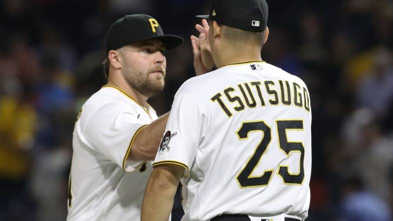 Jul 23, 2022; Pittsburgh, Pennsylvania, USA; Pittsburgh Pirates relief pitcher David Bednar (left) and designated hitter first baseman Yoshi Tsutsugo (25) celebrate after defeating the Miami Marlins at PNC Park. The Pirates shutout the Marlins 1-0. Mandatory Credit: Charles LeClaire-USA TODAY Sports