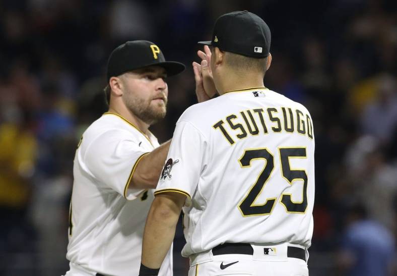 Jul 23, 2022; Pittsburgh, Pennsylvania, USA; Pittsburgh Pirates relief pitcher David Bednar (left) and designated hitter first baseman Yoshi Tsutsugo (25) celebrate after defeating the Miami Marlins at PNC Park. The Pirates shutout the Marlins 1-0. Mandatory Credit: Charles LeClaire-USA TODAY Sports