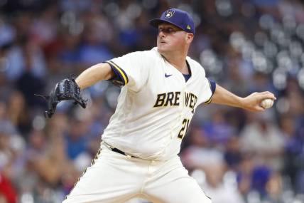 Jul 25, 2022; Milwaukee, Wisconsin, USA;  Milwaukee Brewers pitcher Jake McGee (21) throws a pitch during the seventh inning against the Colorado Rockies at American Family Field. Mandatory Credit: Jeff Hanisch-USA TODAY Sports