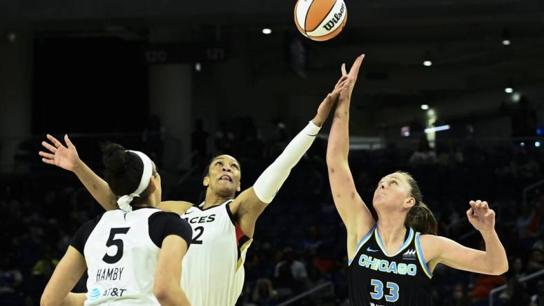 Jul 26, 2022; Chicago, IL, USA;  Chicago Sky forward Emma Meesseman (33) fights for the ball against Las Vegas Aces forward A'ja Wilson (22) and Las Vegas Aces forward Dearica Hamby (5) during the first half of the Commissioners Cup-Championships at Wintrust Arena. Mandatory Credit: Matt Marton-USA TODAY Sports