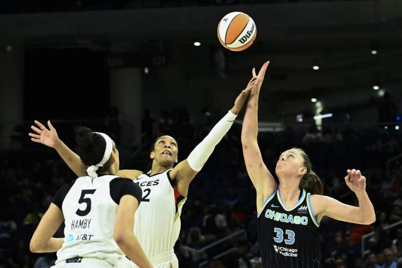 Jul 26, 2022; Chicago, IL, USA;  Chicago Sky forward Emma Meesseman (33) fights for the ball against Las Vegas Aces forward A'ja Wilson (22) and Las Vegas Aces forward Dearica Hamby (5) during the first half of the Commissioners Cup-Championships at Wintrust Arena. Mandatory Credit: Matt Marton-USA TODAY Sports