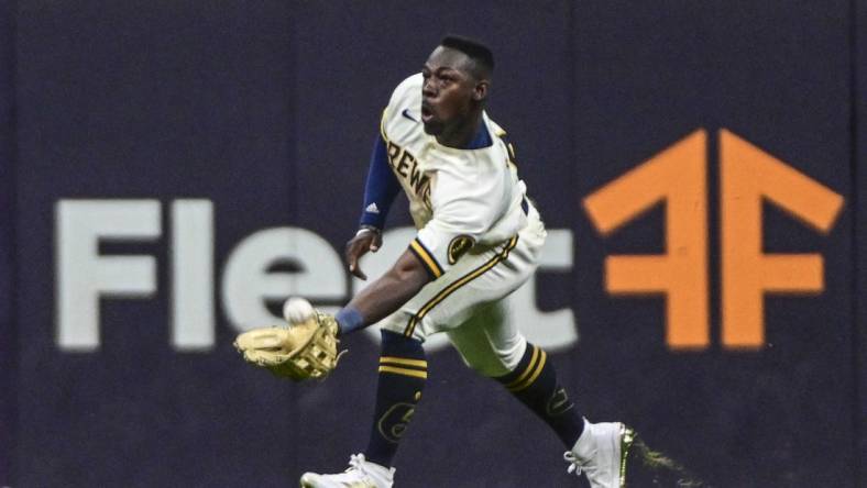 Jul 26, 2022; Milwaukee, Wisconsin, USA;  Milwaukee Brewers center fielder Jonathan Davis (3) catches ball hit by Minnesota Twins third baseman Gio Urshela (not pictured) in the seventh inning at American Family Field. Mandatory Credit: Benny Sieu-USA TODAY Sports