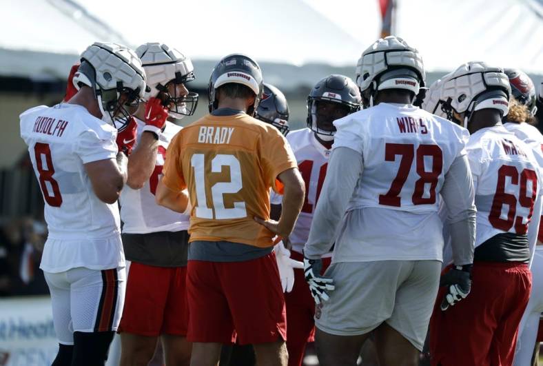 Jul 27, 2022; Tampa, FL, USA; Tampa Bay Buccaneers quarterback Tom Brady (12) huddles up with tight end Kyle Rudolph (8), offensive tackle Tristan Wirfs (78) and teammates at Advent Health Training Complex. Mandatory Credit: Kim Klement-USA TODAY Sports