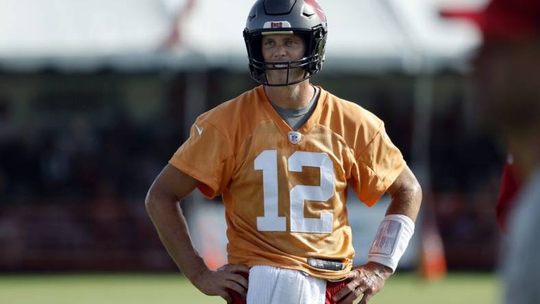 Jul 28, 2022; Tampa, FL, USA;  Tampa Bay Buccaneers quarterback Tom Brady (12) looks on during training camp at AdventHealth Training Center. Mandatory Credit: Kim Klement-USA TODAY Sports