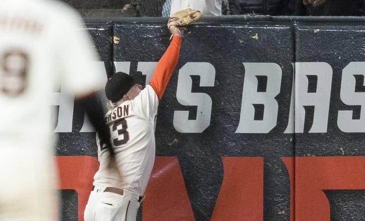 Jul 28, 2022; San Francisco, California, USA;  San Francisco Giants left fielder Joc Pederson (23) misses a deep fly ball to allow Chicago Cubs third baseman Patrick Wisdom (16) a two-run home run during the seventh inning at Oracle Park. Mandatory Credit: John Hefti-USA TODAY Sports