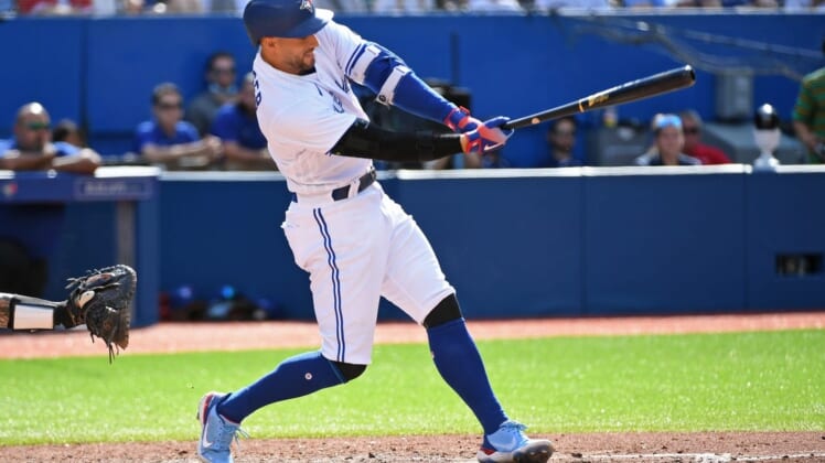 Jul 30, 2022; Toronto, Ontario, CAN; Toronto Blue Jays designated hitter George Springer (4) hits a fielders choice single in the sixth inning again the Detroit Tigers at Rogers Centre. Mandatory Credit: Gerry Angus-USA TODAY Sports
