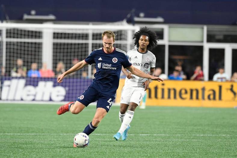 Jul 30, 2022; Foxborough, MA, USA; New England Revolution defender Henry Kessler (4) controls the ball in front of Toronto FC forward Jayden Nelson (11) during the first half at Gillette Stadium. Mandatory Credit: Eric Canha-USA TODAY Sports