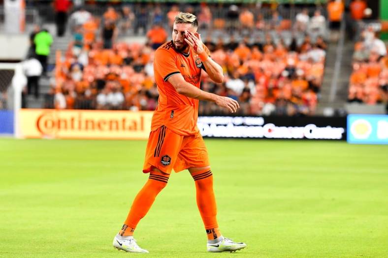 Jul 23, 2022; Houston, Texas, USA;  Houston Dynamo FC midfielder Hector Herrera (16) motions to the sideline as he bleeds from a header during the first half against the Minnesota United FC at PNC Stadium. Mandatory Credit: Maria Lysaker-Houston Dynamo FC-USA TODAY Sports