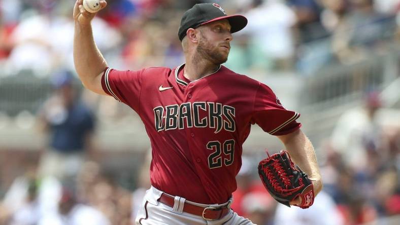 Jul 31, 2022; Atlanta, Georgia, USA; Arizona Diamondbacks starting pitcher Merrill Kelly (29) throws against the Atlanta Braves in the second inning at Truist Park. Mandatory Credit: Brett Davis-USA TODAY Sports