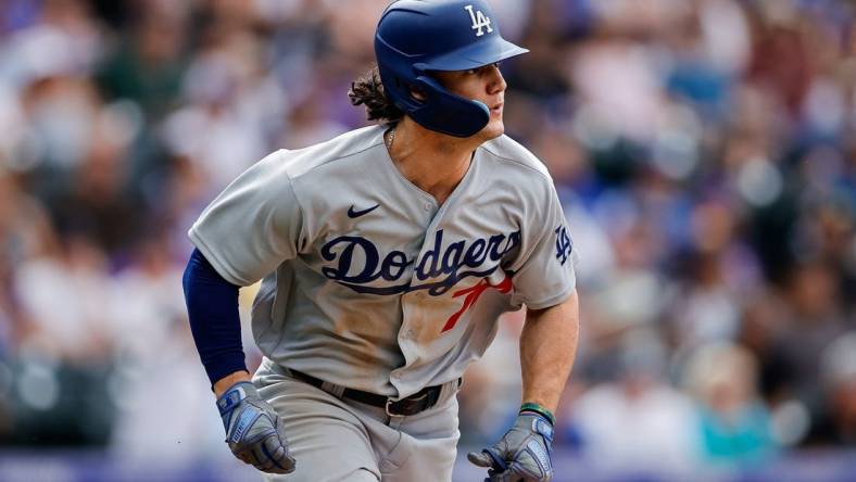 Jul 31, 2022; Denver, Colorado, USA; Los Angeles Dodgers right fielder James Outman (77) watches his ball on an RBI double in the eighth inning against the Colorado Rockies at Coors Field. Mandatory Credit: Isaiah J. Downing-USA TODAY Sports