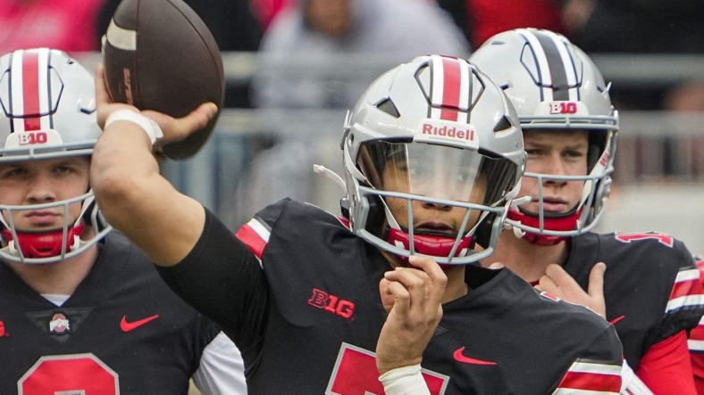 Ohio State Buckeyes quarterback C.J. Stroud, center, throws in front of quarterbacks Kyle McCord, left, and Devin Brown during the spring football game at Ohio Stadium in Columbus on April 16, 2022.Cj Stroud Spring Game