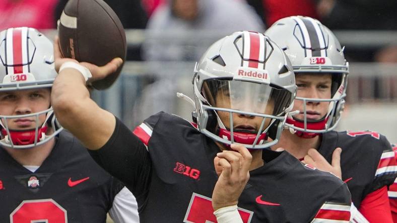 Ohio State Buckeyes quarterback C.J. Stroud, center, throws in front of quarterbacks Kyle McCord, left, and Devin Brown during the spring football game at Ohio Stadium in Columbus on April 16, 2022.

Cj Stroud Spring Game