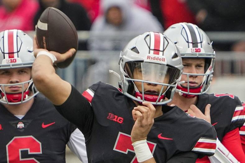 Ohio State Buckeyes quarterback C.J. Stroud, center, throws in front of quarterbacks Kyle McCord, left, and Devin Brown during the spring football game at Ohio Stadium in Columbus on April 16, 2022.

Cj Stroud Spring Game
