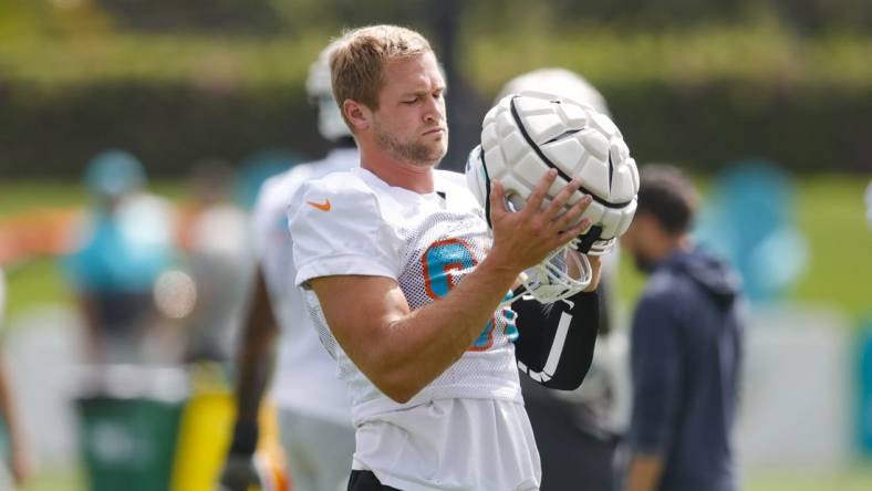 Aug 1, 2022; Miami Gardens, Florida, US; Miami Dolphins tight end Mike Gesicki (88) puts his helmet on during training camp at Baptist Health Training Complex. Mandatory Credit: Sam Navarro-USA TODAY Sports