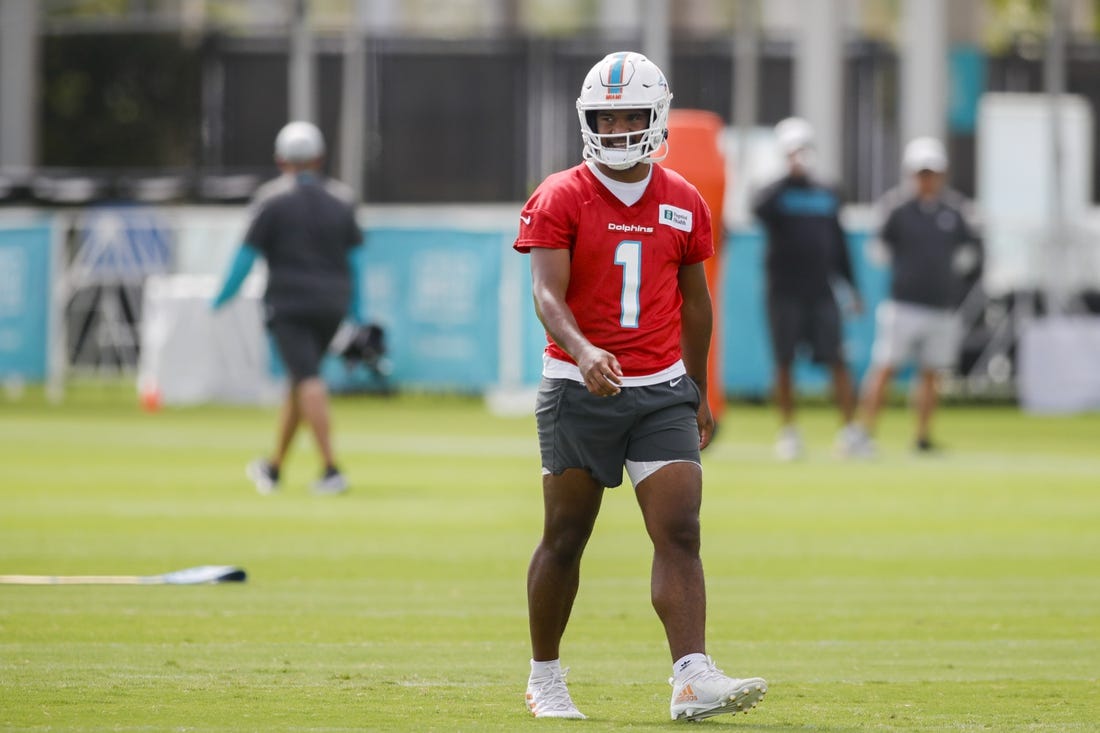 Aug 1, 2022; Miami Gardens, Florida, US; Miami Dolphins quarterback Tua Tagovailoa (1) watches from the field during training camp at Baptist Health Training Complex. Mandatory Credit: Sam Navarro-USA TODAY Sports