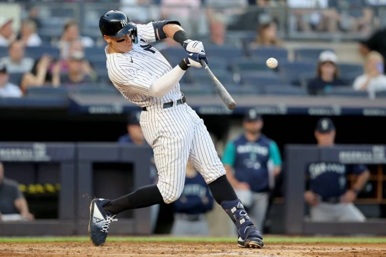 Aug 1, 2022; Bronx, New York, USA; New York Yankees right fielder Aaron Judge (99) hits a two run home run against the Seattle Mariners during the second inning at Yankee Stadium. Mandatory Credit: Brad Penner-USA TODAY Sports