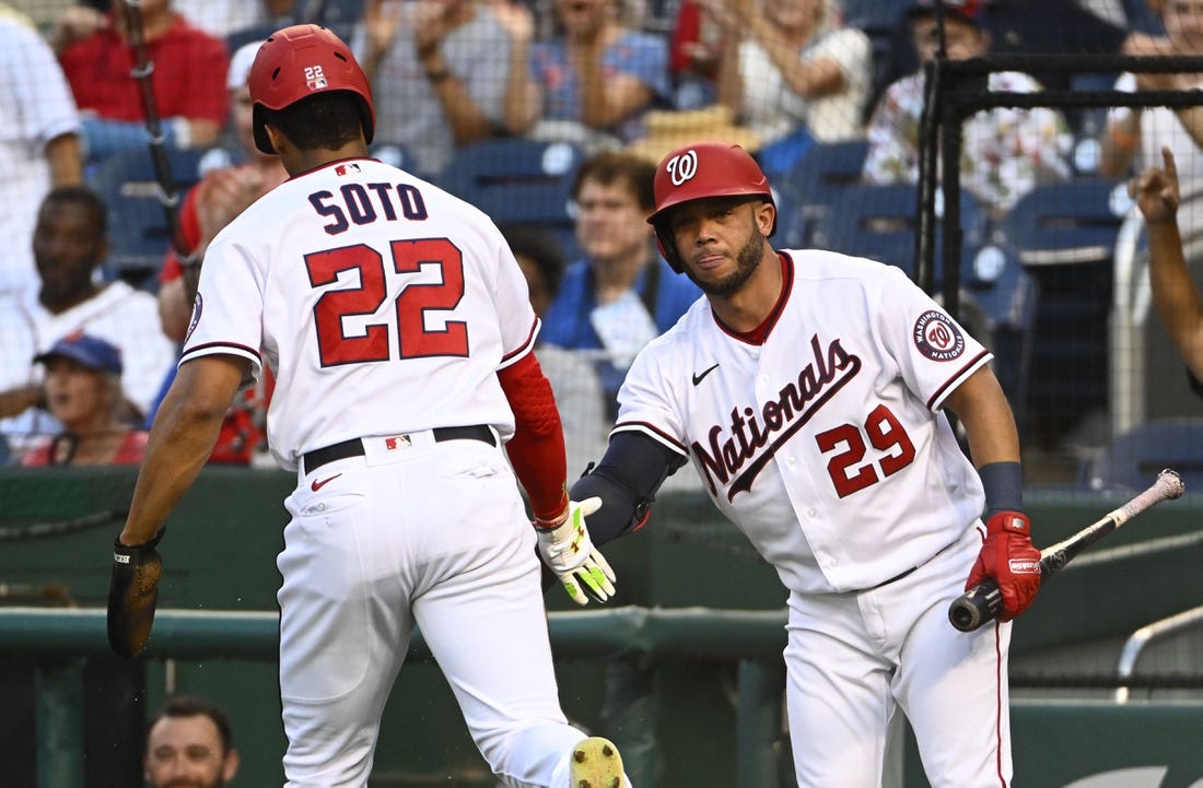 Aug 1, 2022; Washington, District of Columbia, USA; Washington Nationals right fielder Juan Soto (22) is congratulated by left fielder Yadiel Hernandez (29) after scoring a run against the New York Mets during the first inning at Nationals Park. Mandatory Credit: Brad Mills-USA TODAY Sports