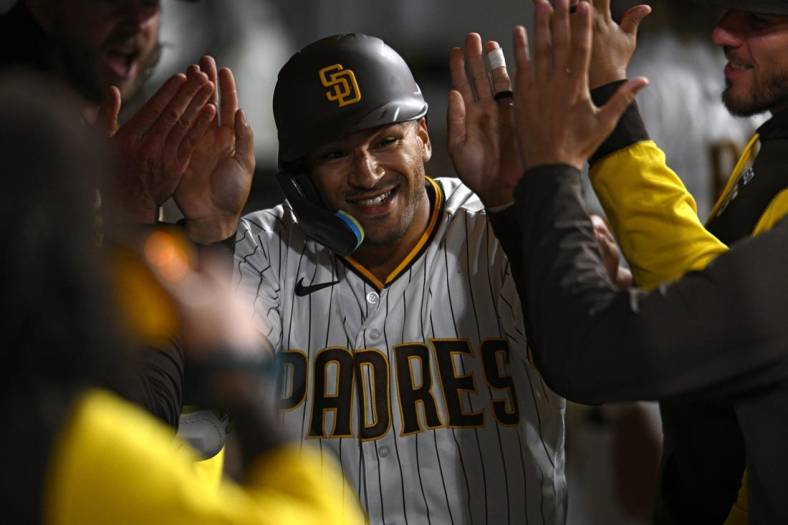 Aug 1, 2022; San Diego, California, USA; San Diego Padres center fielder Trent Grisham (2) is congratulated in the dugout after hitting a home run against the Colorado Rockies during the seventh inning at Petco Park. Mandatory Credit: Orlando Ramirez-USA TODAY Sports