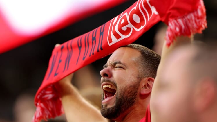 Aug 2, 2022; Harrison, New Jersey, USA; A New York Red Bulls fan holds a scarf and cheers during the national anthem before the game between the Red Bulls and the Colorado Rapids at Red Bull Arena. Mandatory Credit: Vincent Carchietta-USA TODAY Sports