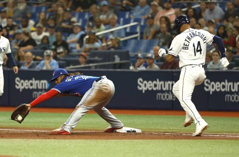 Aug 2, 2022; St. Petersburg, Florida, USA;  Toronto Blue Jays first baseman Vladimir Guerrero Jr. (27) forces out Tampa Bay Rays first baseman Christian Bethancourt (14) during the second inning at Tropicana Field. Mandatory Credit: Kim Klement-USA TODAY Sports