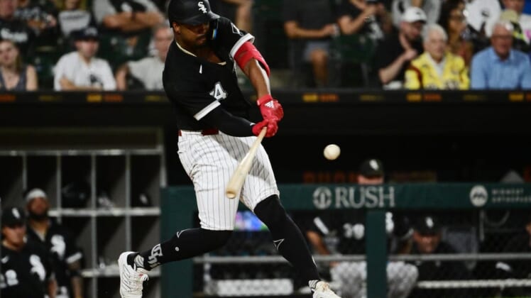 Aug 2, 2022; Chicago, Illinois, USA; Chicago White Sox left fielder Eloy Jimenez (74) hits a sacrifice fly in the sixth inning against the Kansas City Royals at Guaranteed Rate Field. Mandatory Credit: Quinn Harris-USA TODAY Sports