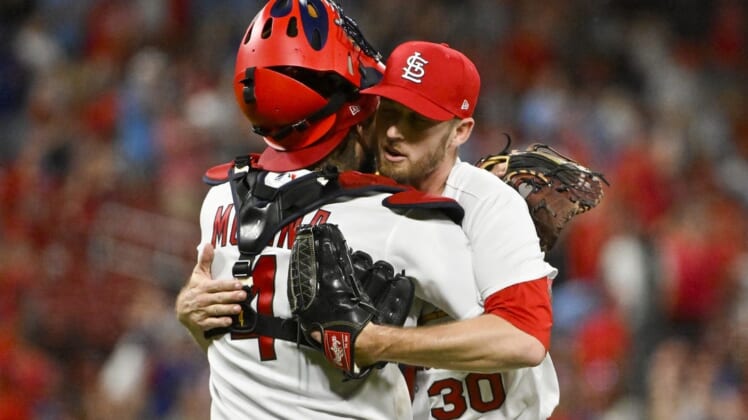 Aug 2, 2022; St. Louis, Missouri, USA;  St. Louis Cardinals relief pitcher Chris Stratton (30) celebrates with catcher Yadier Molina (4) after the Cardinals defeated the Chicago Cubs at Busch Stadium. Mandatory Credit: Jeff Curry-USA TODAY Sports
